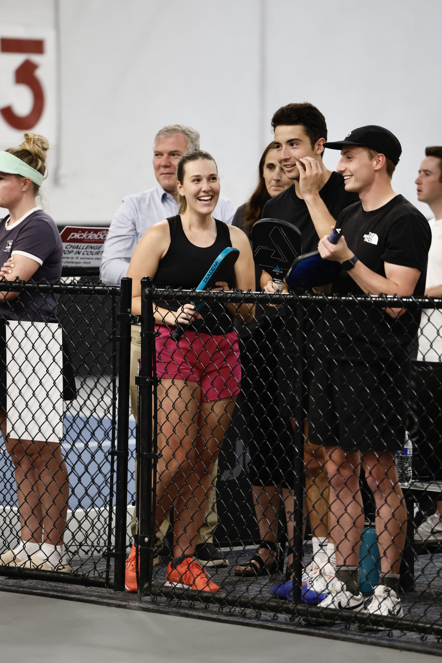 Club Pickleball USA players laughing at the net